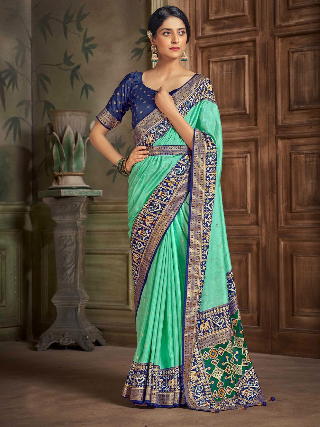 

Mitera Sea Green Geometric Woven Design Zari Detailed Patola Saree
