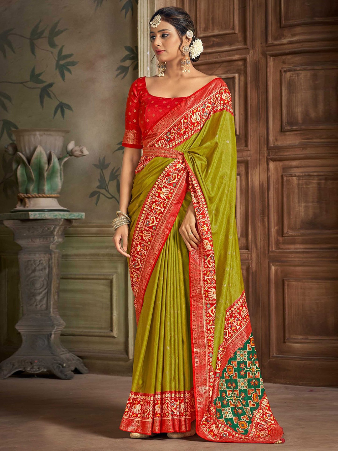 

Mitera Green Geometric Woven Design Zari Detailed Patola Saree
