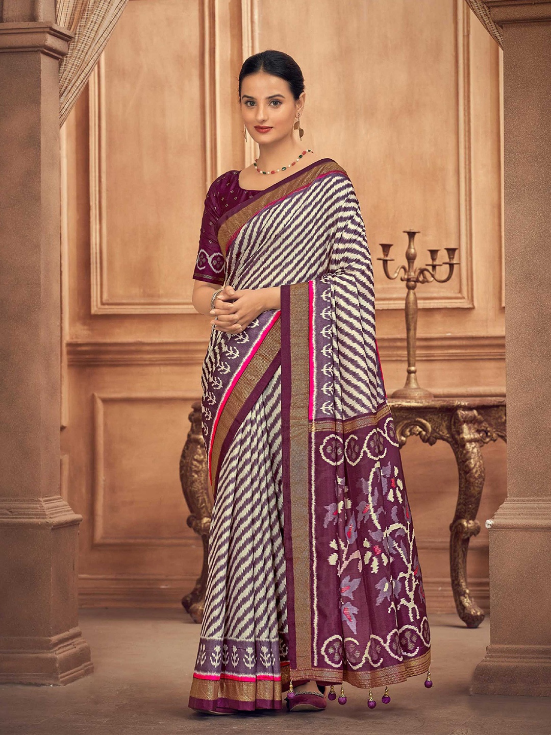 

Mitera Purple Leheriya Printed Zari Detailed Patola Saree
