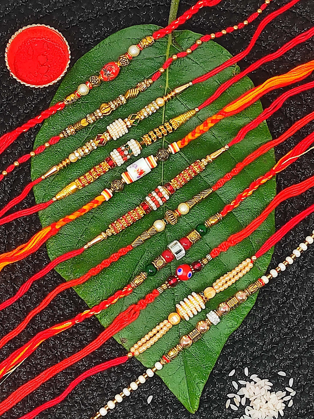 

CRAYTON Set Of 11 Charm Detail Rakhi, Red