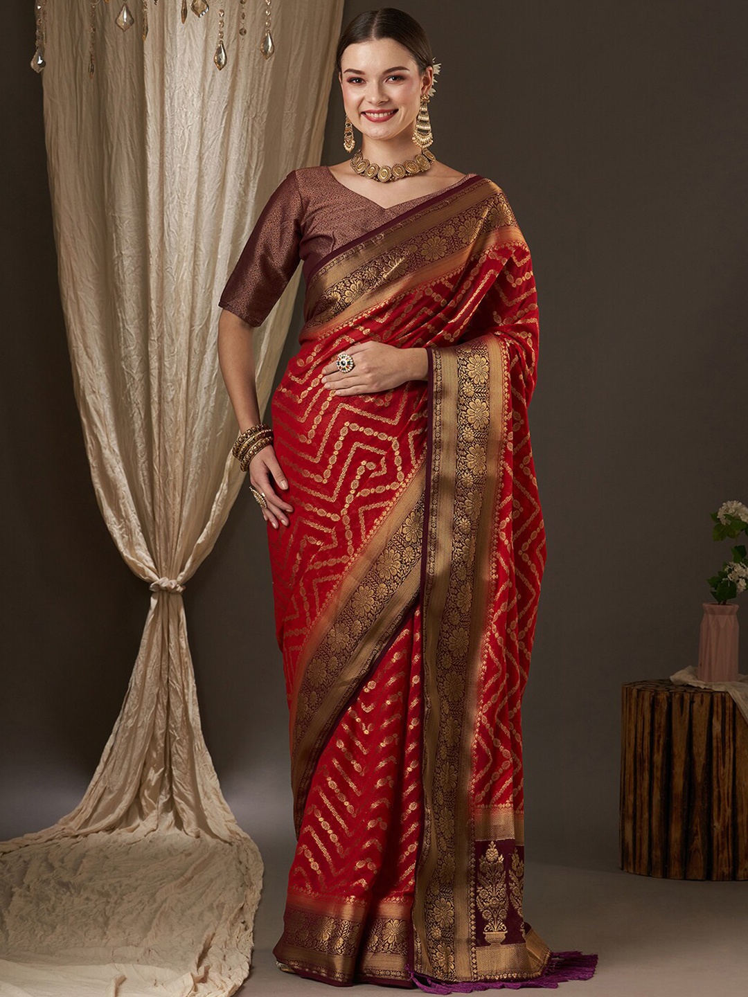 

Anouk Maroon & Red Woven Design Zari Pure Georgette Kanjeevaram Saree