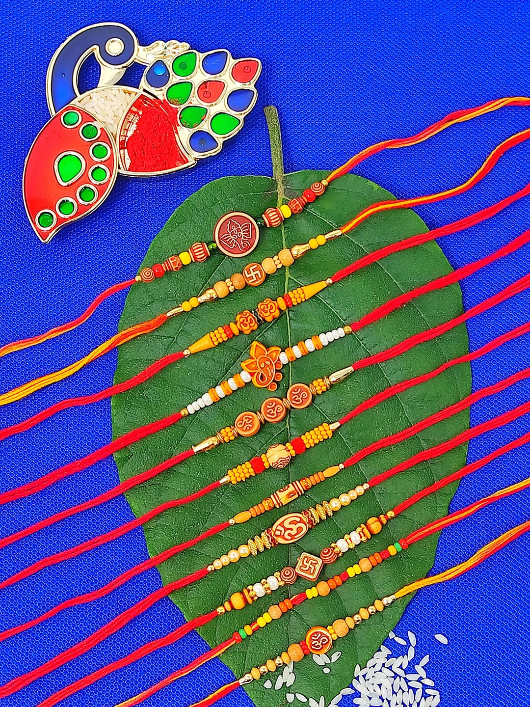 

CRAYTON Men Set Of 11 Rakhi With Roli Chaval Holder, Red