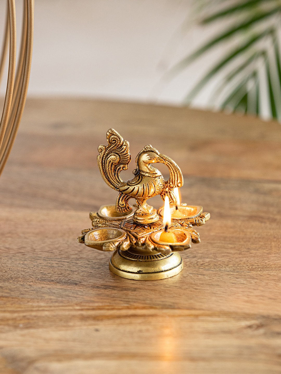

ExclusiveLane The Brass Beams Yellow Textured Peacock-Shaped Brass Diya, Gold