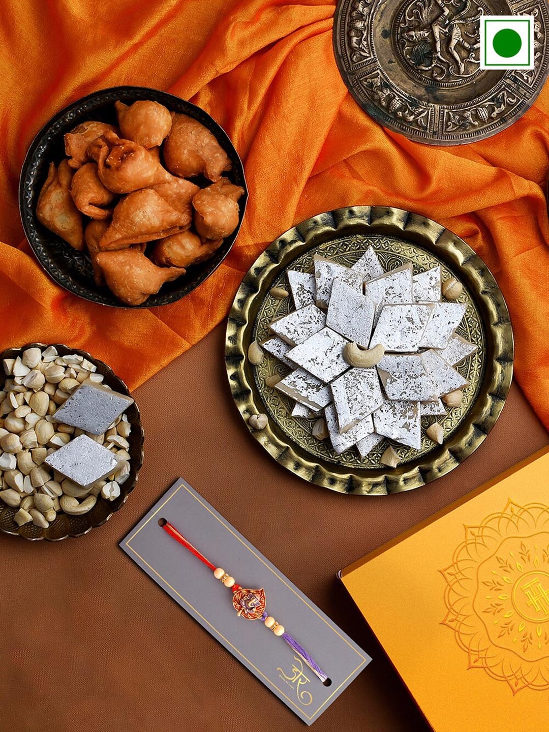 

RawFruit Ganesha Charm Rakhi With Sweets Savoury Gift Set, Red
