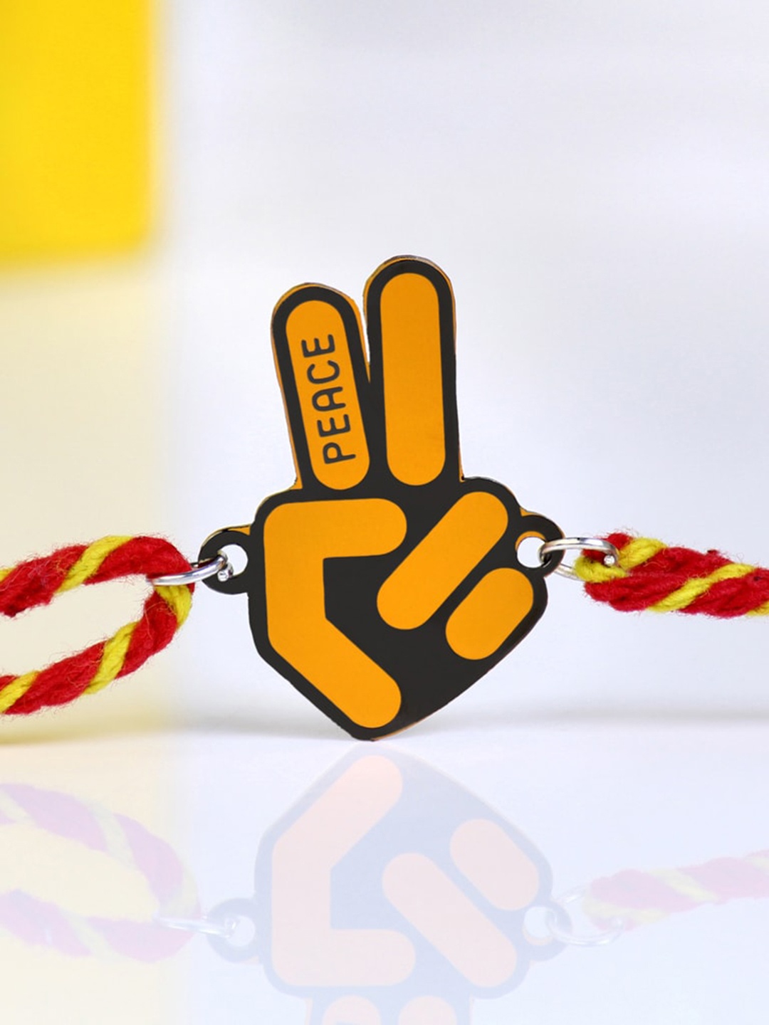 

Bigsmall Peace Metallic Charm Rakhi, Yellow