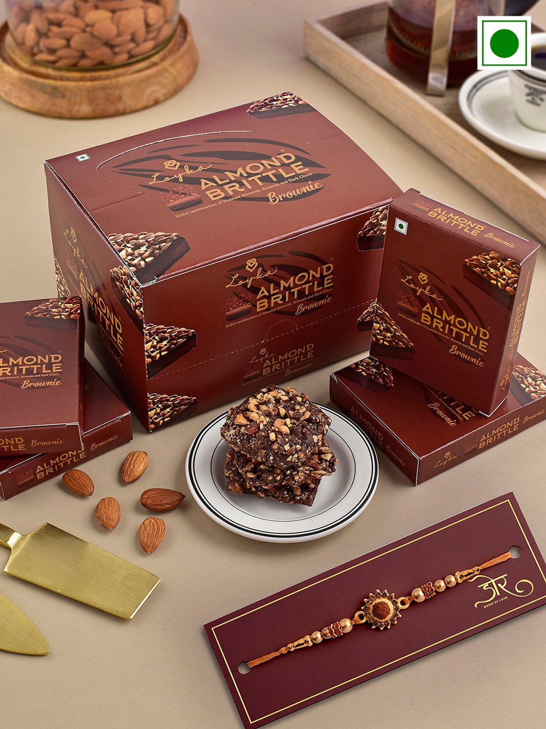 

Hyperfoods Stone-Studded Rakhi With Loyka Almond Brittle Brownie Chocolate Set, Brown