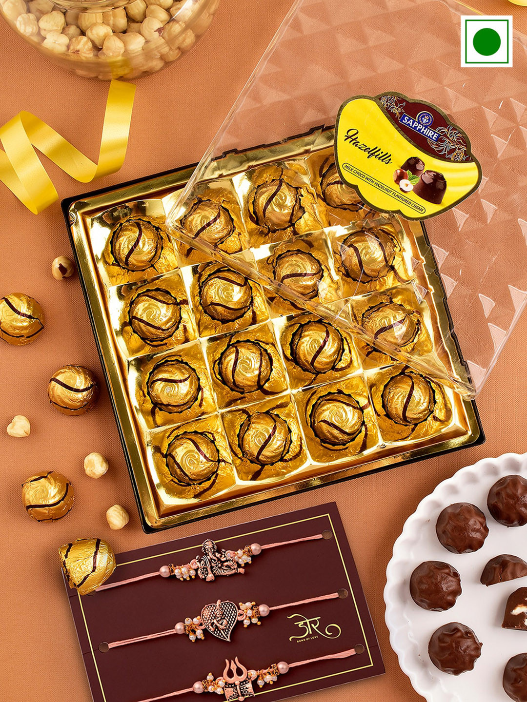 

Hyperfoods Set Of 3 Charm Rakhis With Sapphire Hazelfills Chocolates Gift Set, Gold