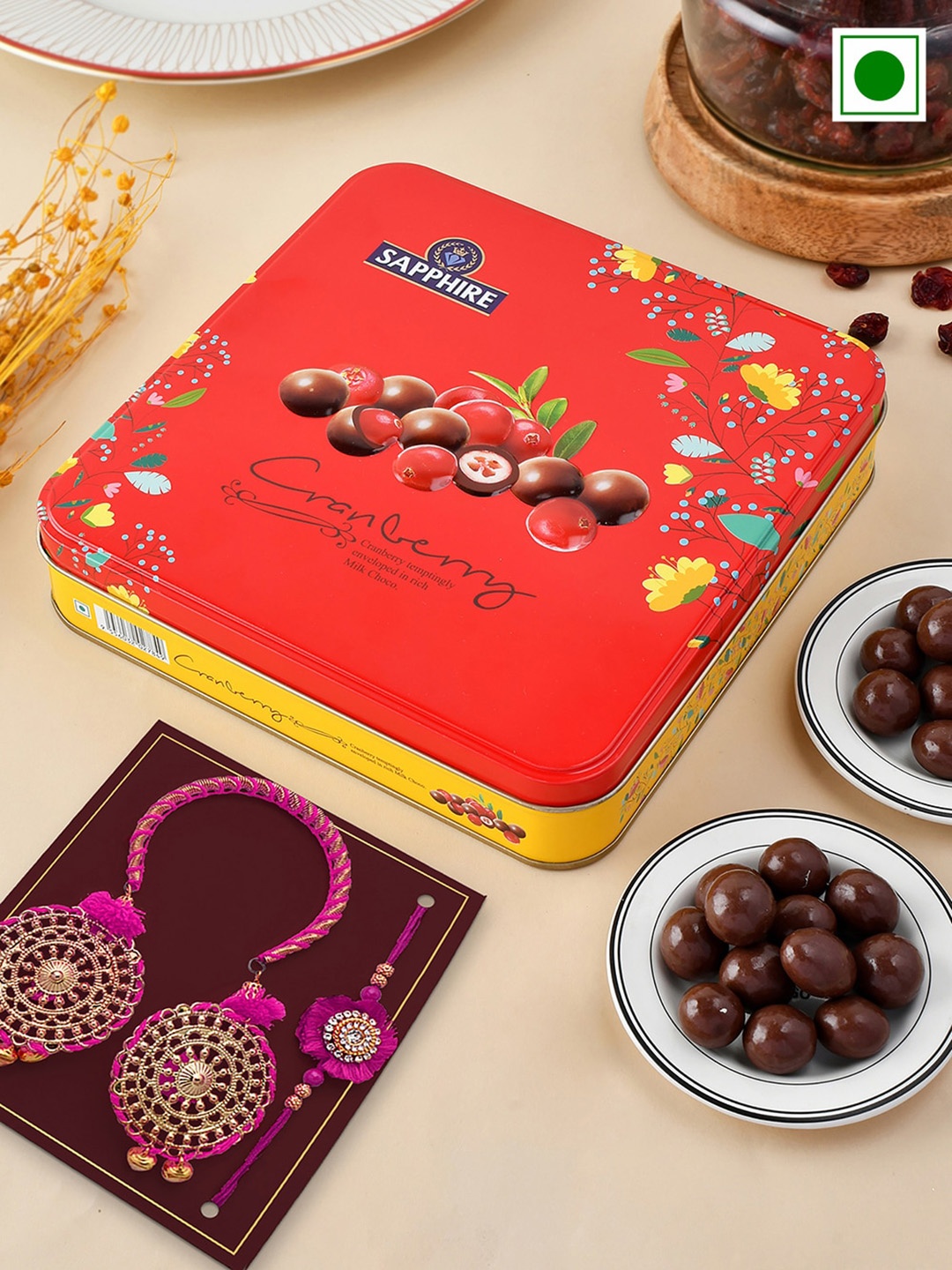 

Hyperfoods Set Of 2 Rakhi With Sapphire Chocolate Coated Cranberry Set, Orange