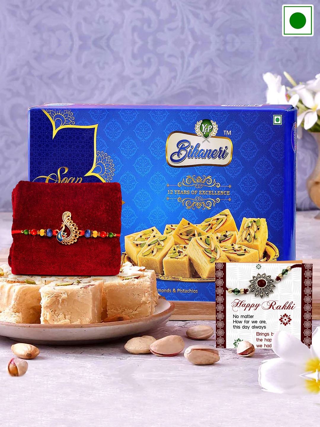 

TIED RIBBONS Peacock Charm Rakhi With Roli Chawal & Soan Papdi Sweet-250 gms, Red