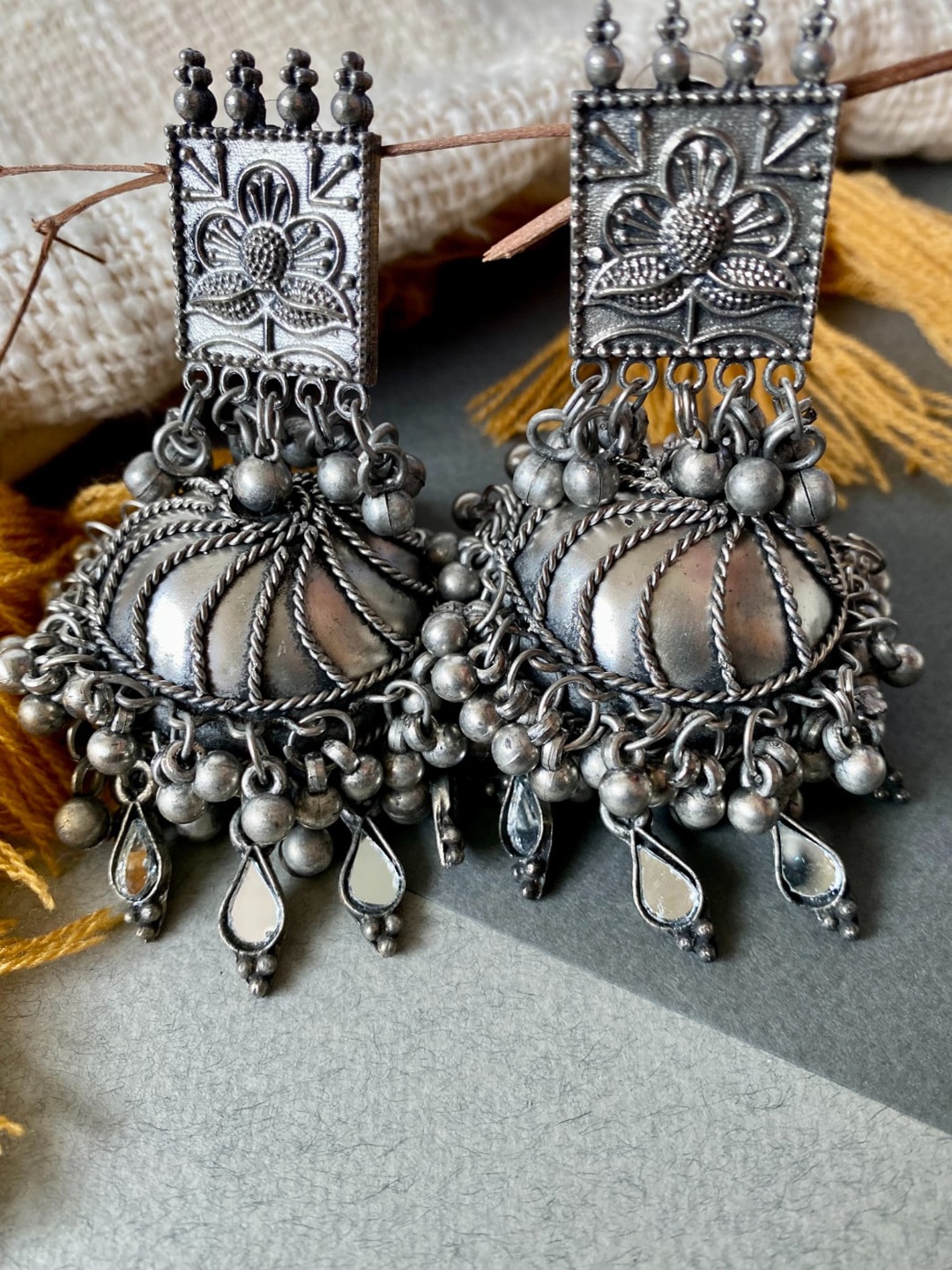 

Pihtara Jewels Silver-Plated Dome Shaped Oxidised Jhumkas