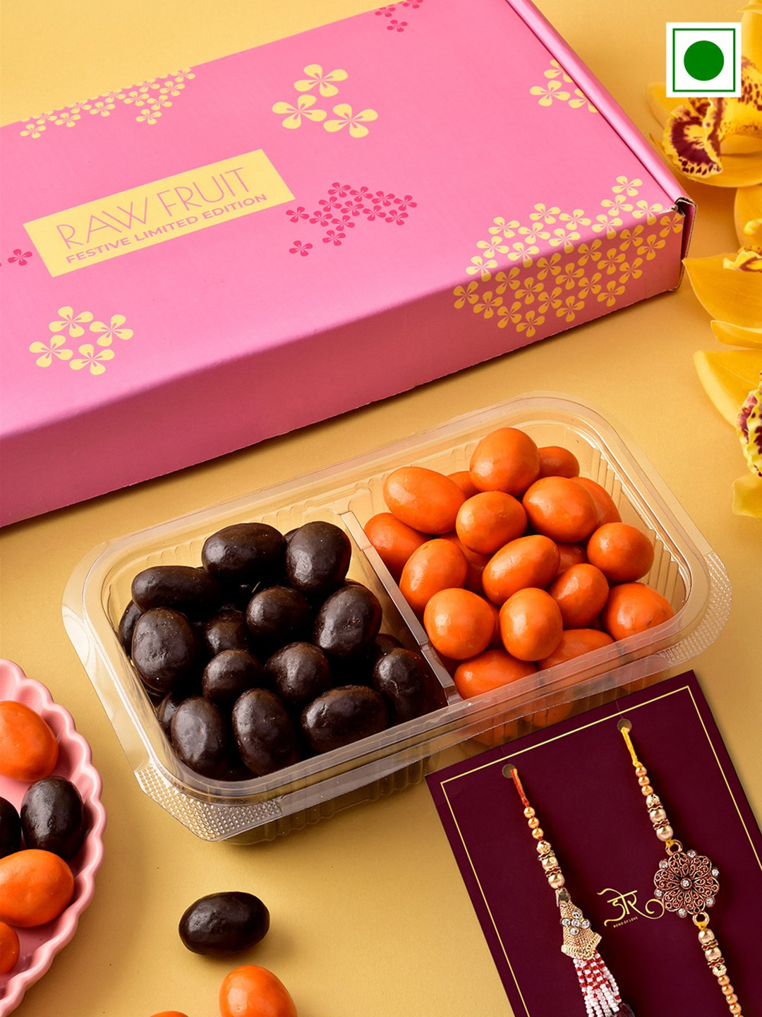 

RawFruit Orange And Dark Chocolate Dragees With Bhai Bhabhi Rakhi 320gms, White