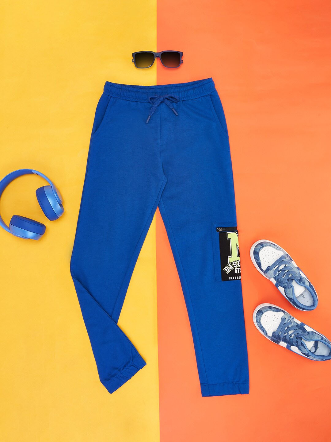 

Pantaloons Junior Boys Graphic Printed Cotton Mid-Rise Relaxed Fit Track Pant, Blue