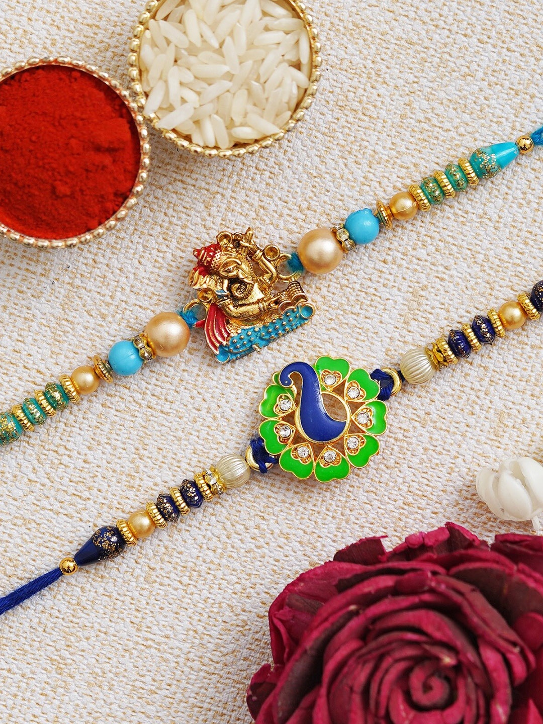 

Fashion Bizz Set of 2 Peacock & Ganesha Charm Rakhis Comes With Roli & Chawal, Blue