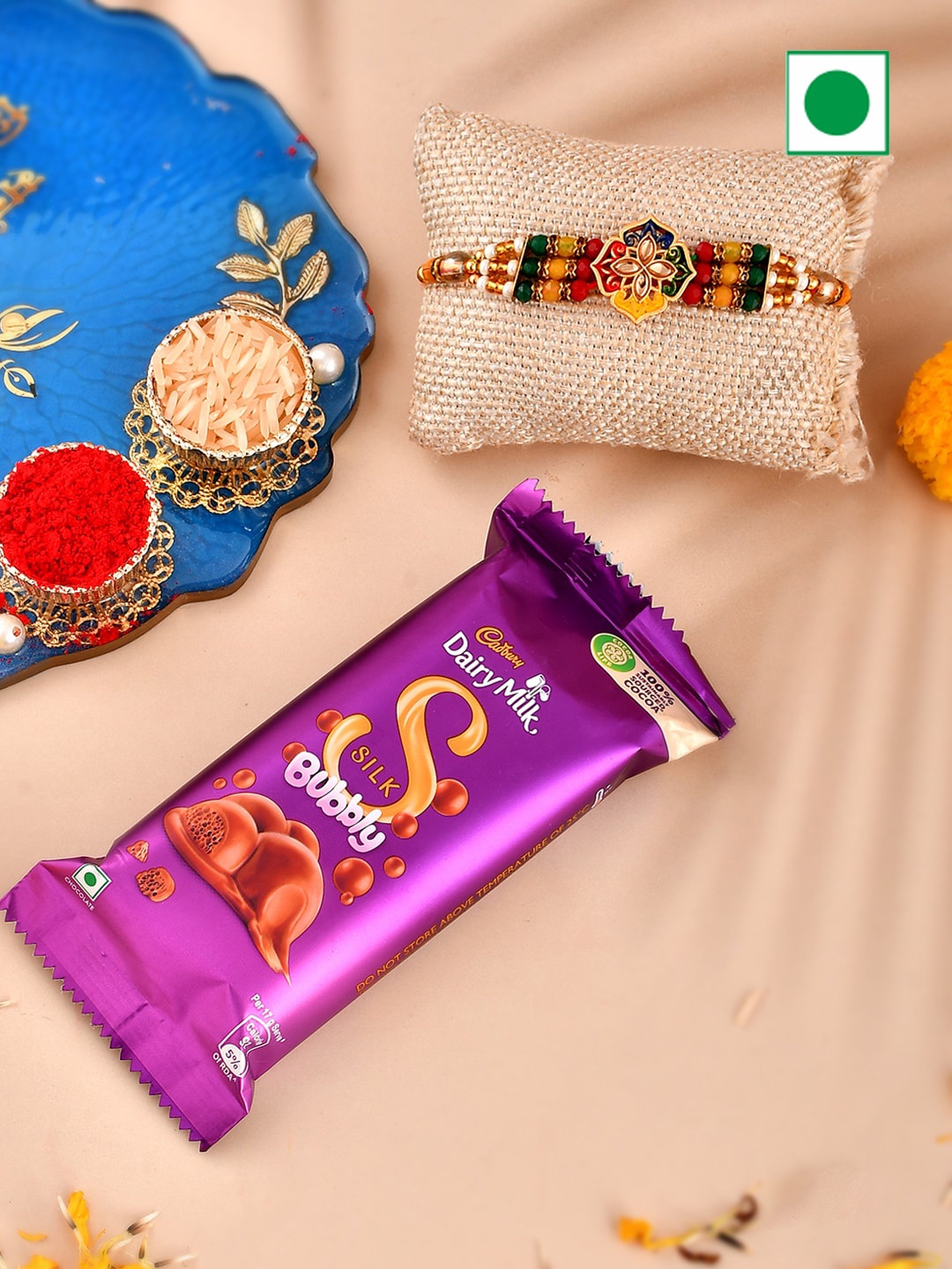

Aapno Rajasthan Set Of 3 Ganesh & Floral Beaded Rakhi With Dairy Milk Silk Bubbly, Gold