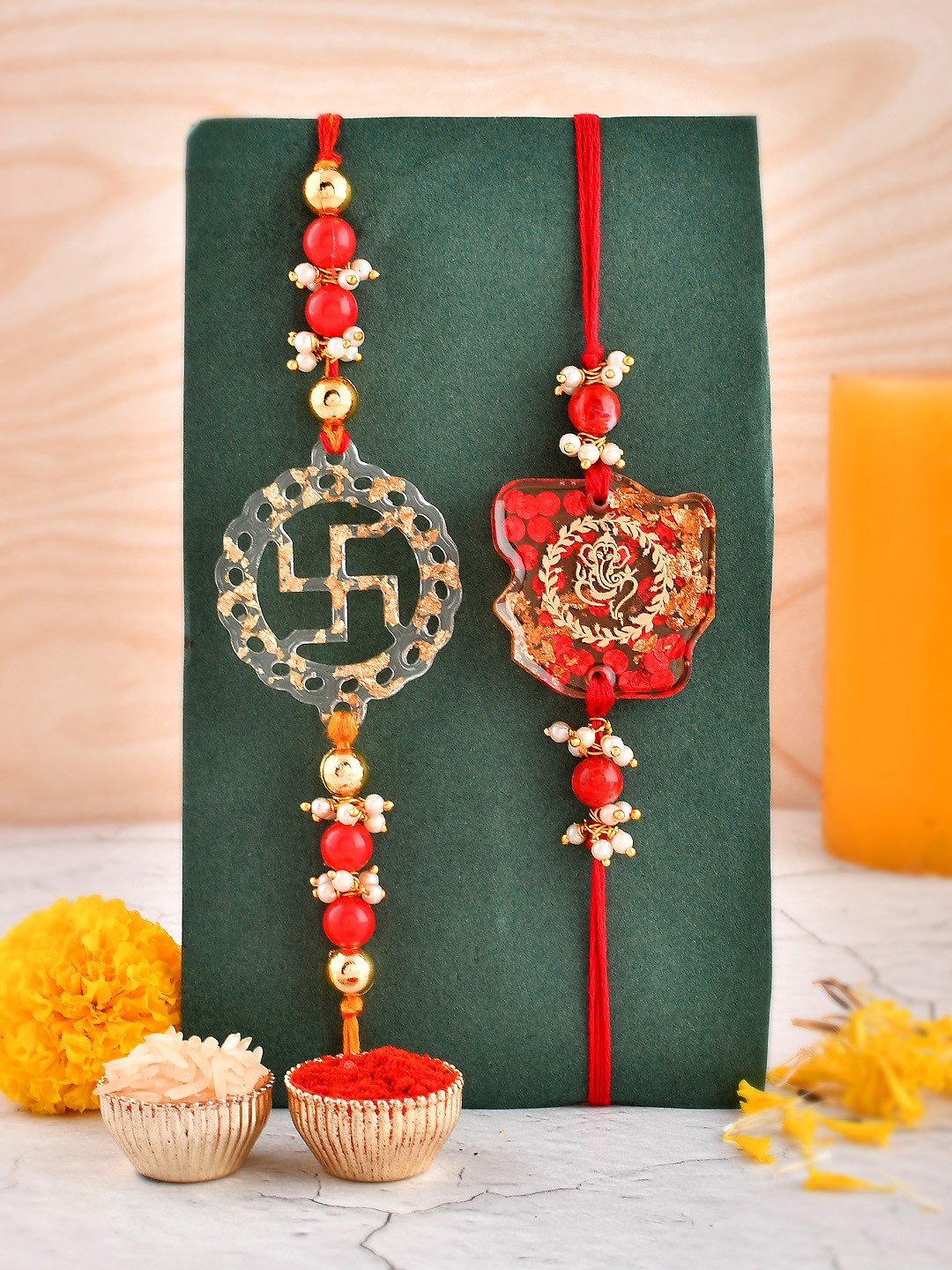

Aapno Rajasthan Unisex Set Of 2 Ganesha & Swastik Charm Thread Rakhis, Red