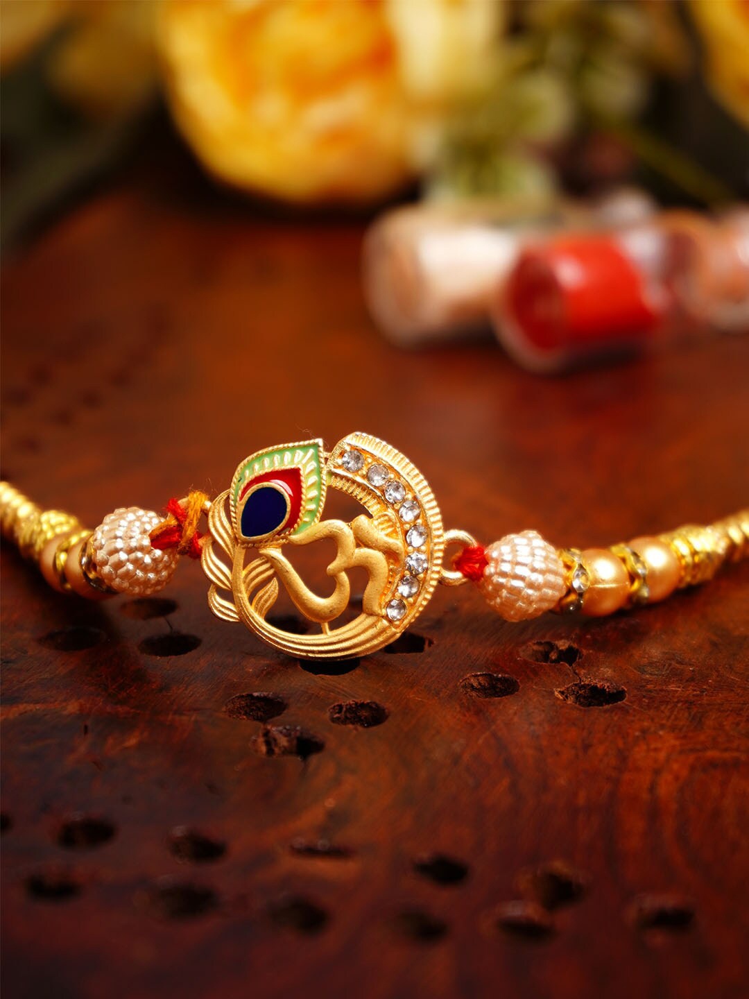 

Urmika Om With Mor Pankh Charm Rakhi With Roli Chawal, Gold