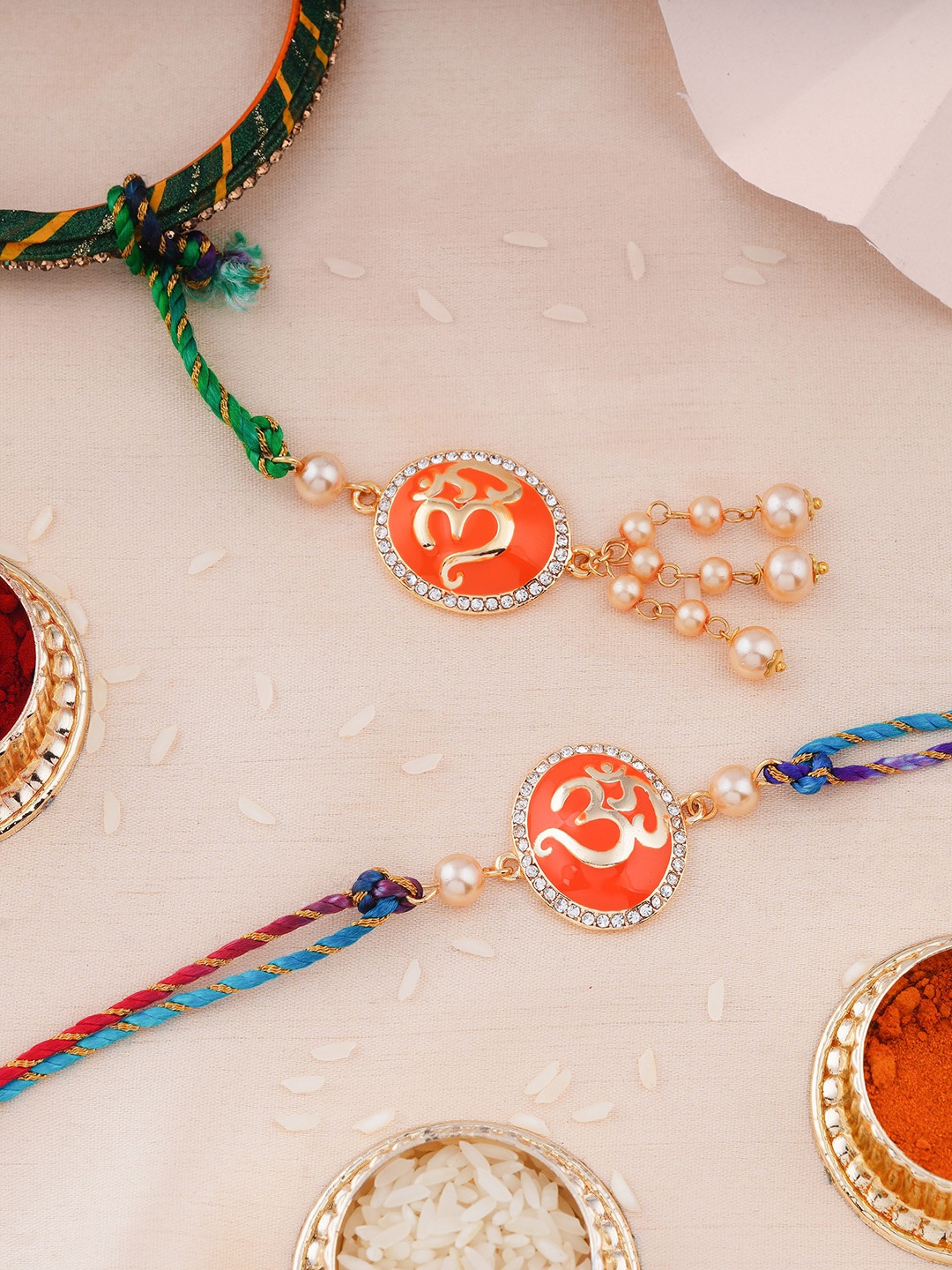 

Estele Set Of 2 Om Charm Rakhis With Roli Chawal, Blue