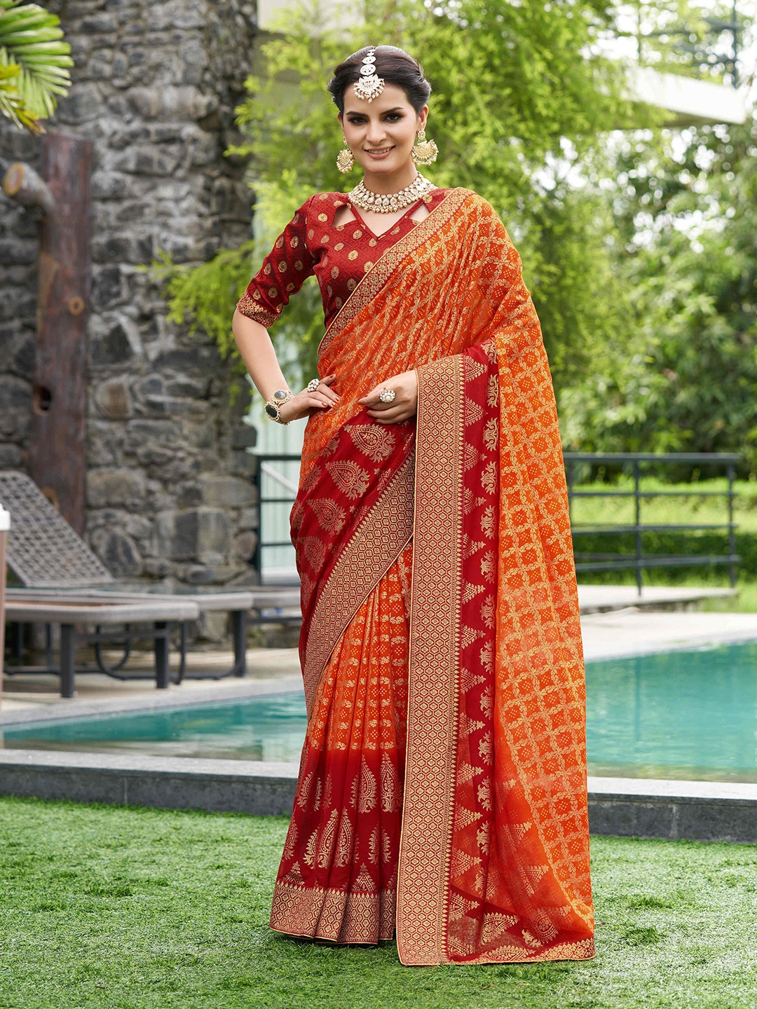 

Mitera Orange & Red Ethnic Motifs Printed Pure Georgette Zari Saree