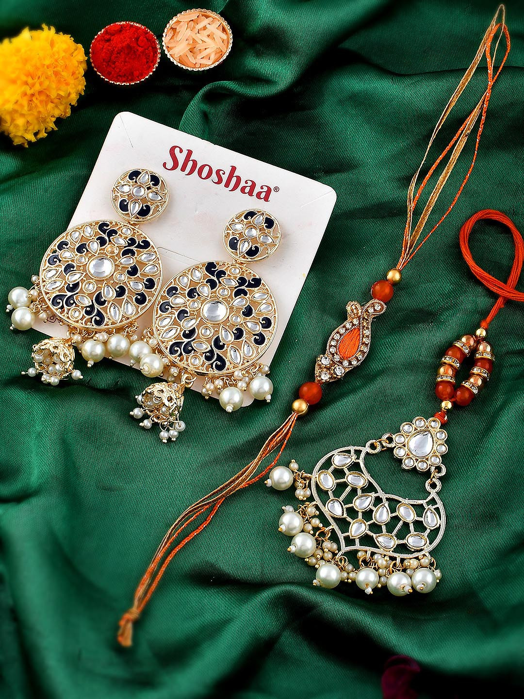 

Shoshaa Unisex Set O f 4 Rakhi & Lumba Maangtika With Earrings Gift Set & Roli Chawal, Orange