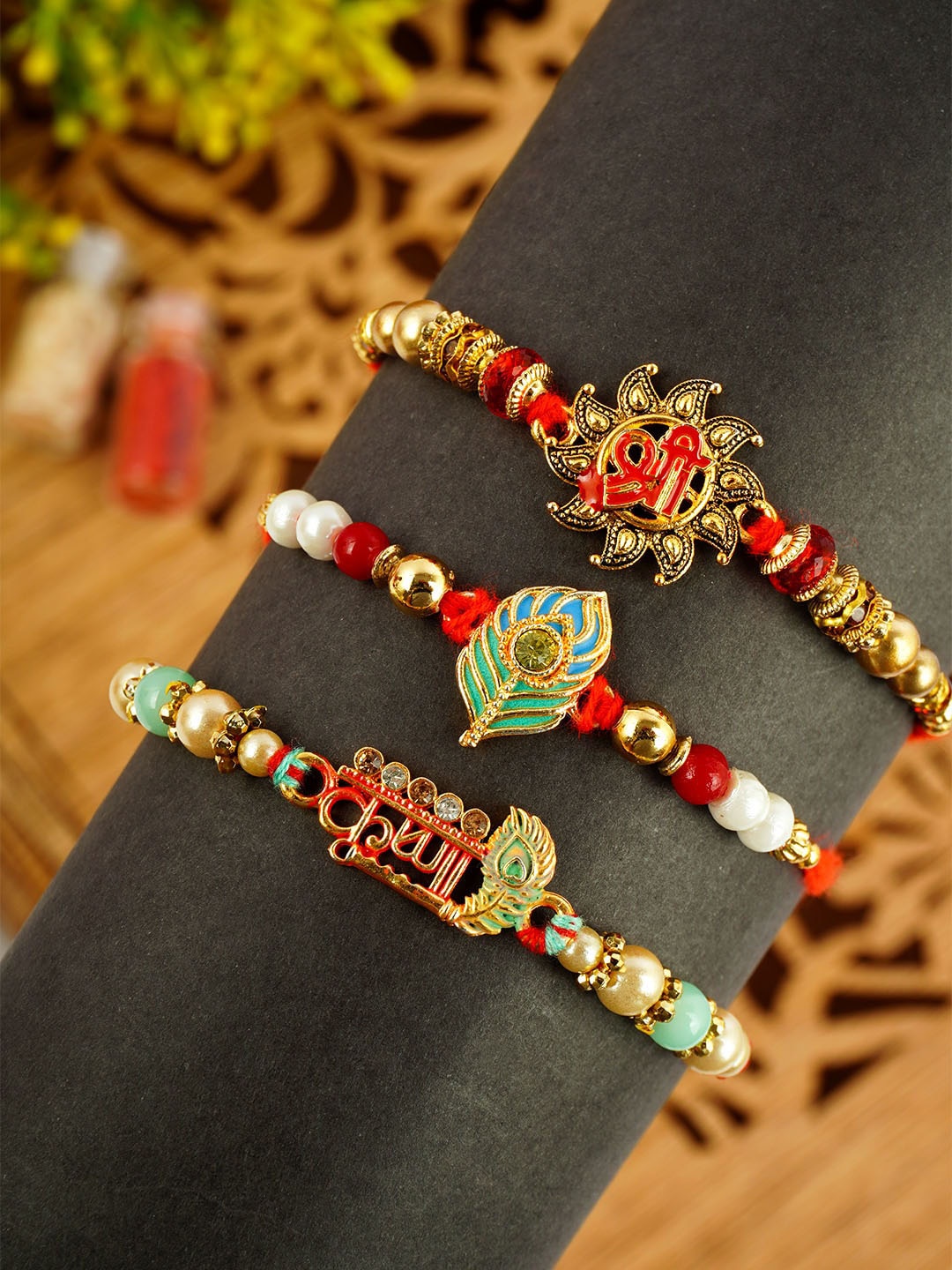 

Urmika Set Of 3 Shri Krishna Thread Rakhis, Red