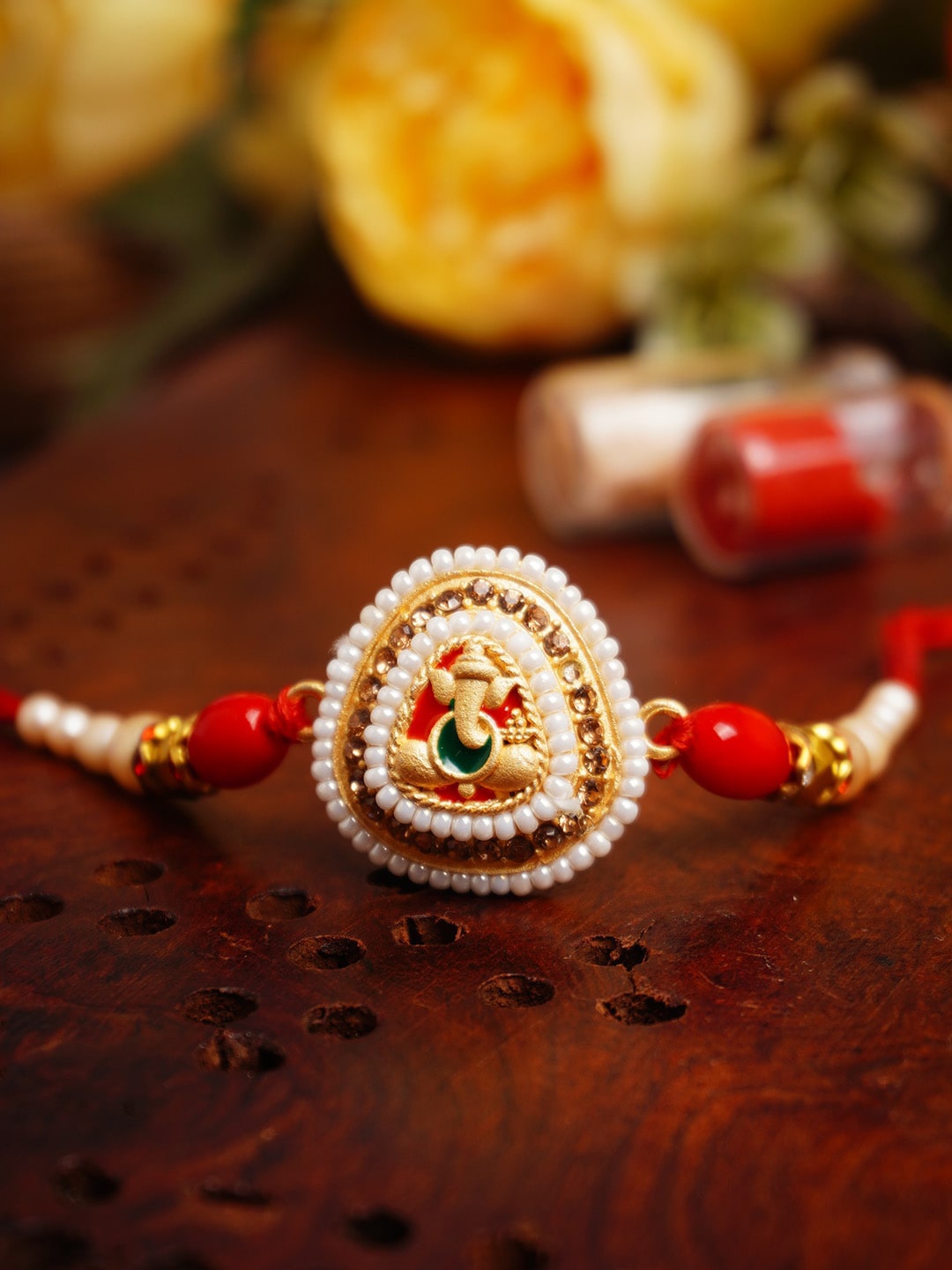 

Urmika Ganesha Pearls Thread Rakhi, Gold