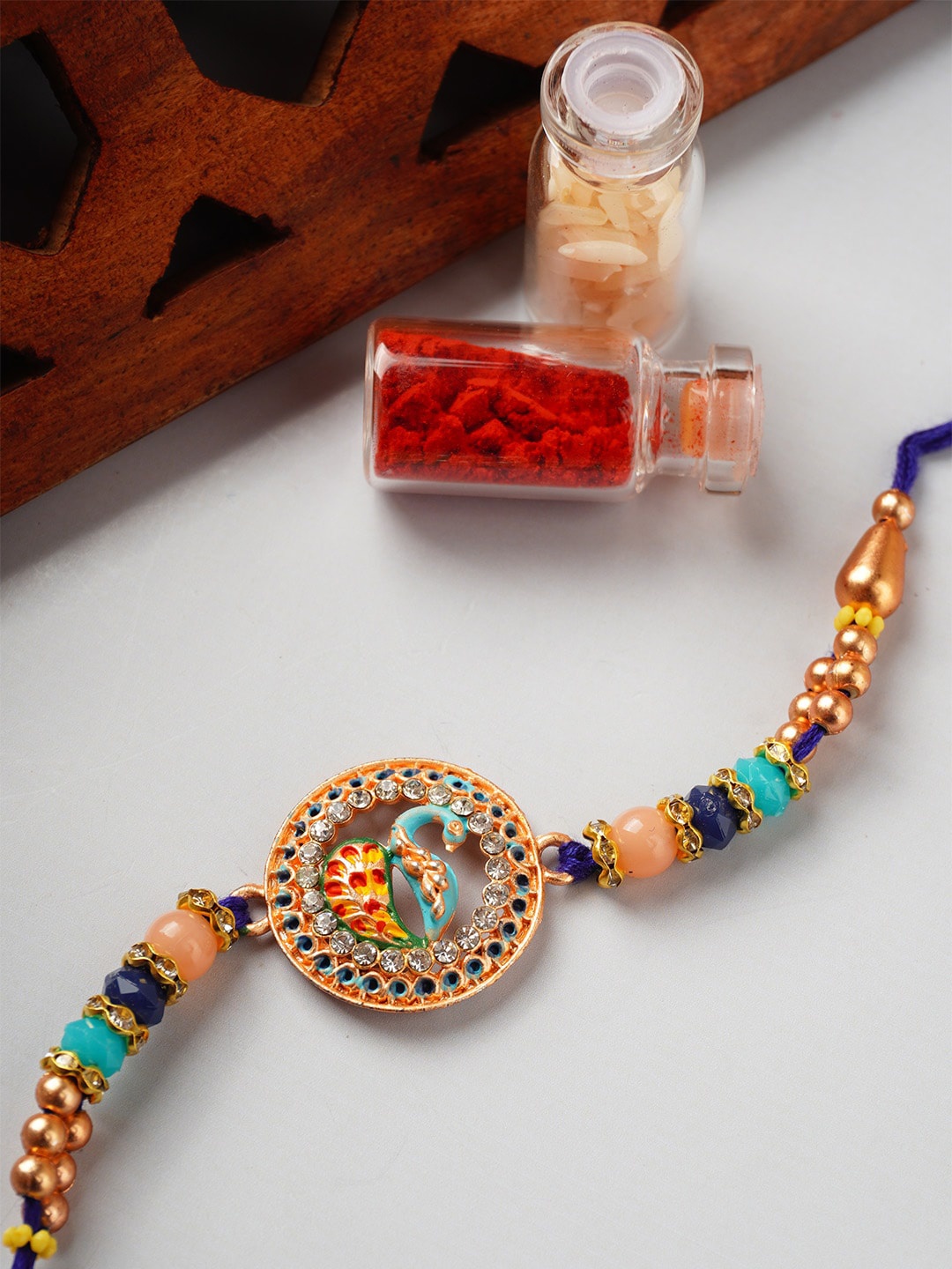 

Urmika Unisex Peacock Rakhi With Roli Chawal, Gold