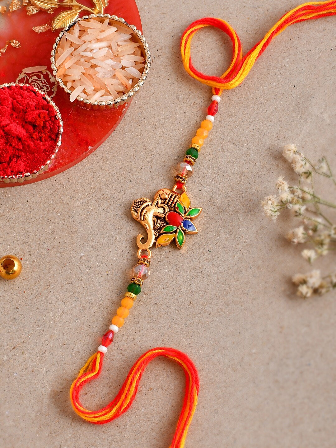 

Aapno Rajasthan Ganesha Charm Rakhi, Gold