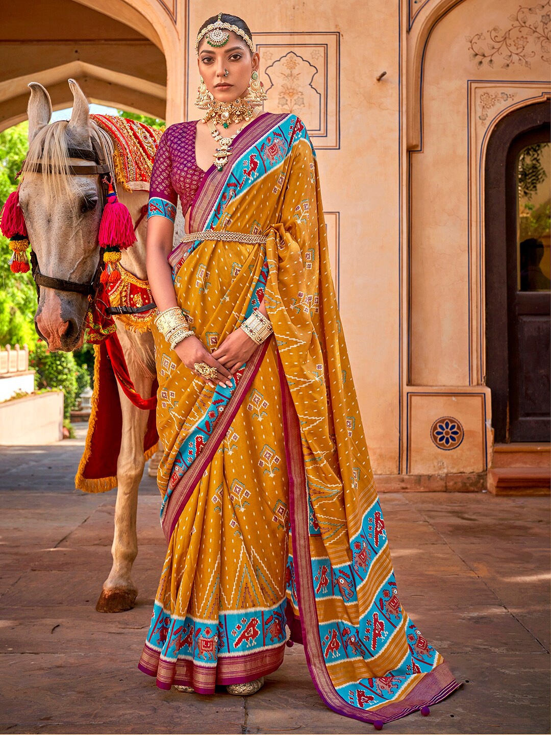 

Anouk Mustard & Blue Ethnic Motifs Printed Zari Patola Saree
