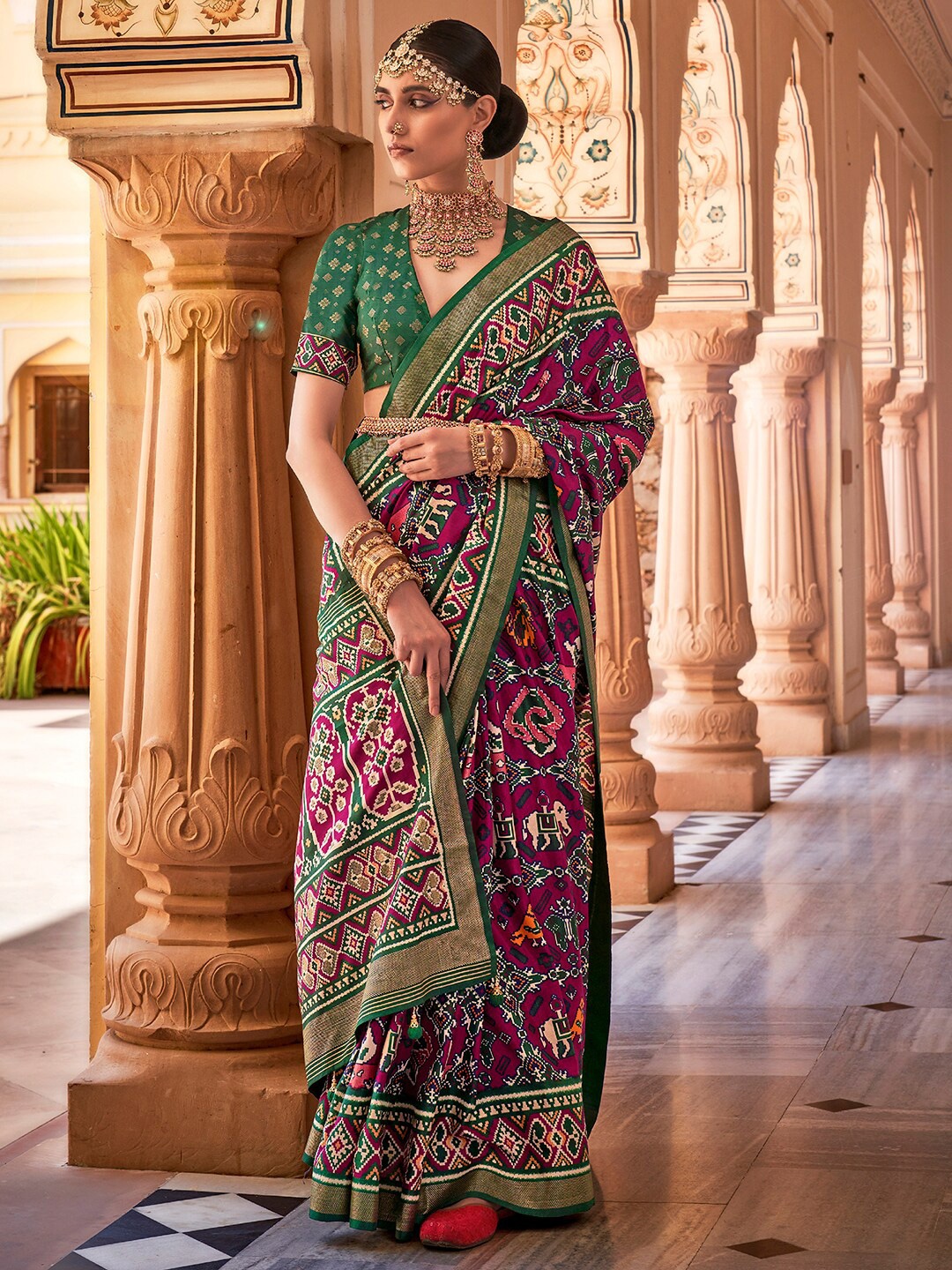 

Anouk Magenta & Green Ethnic Motifs Printed Zari Patola Saree