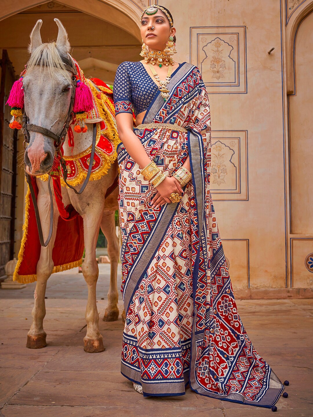 

Anouk Cream-Coloured & Red Ethnic Motifs Printed Zari Patola Saree
