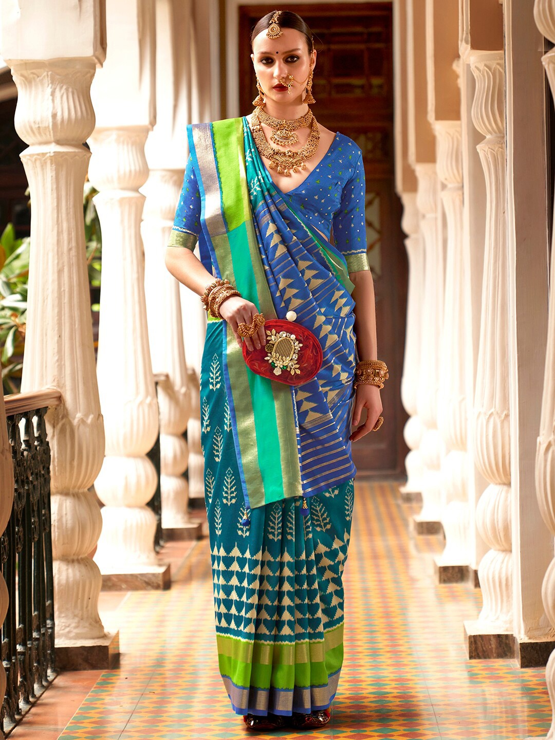 

Anouk Teal & Gold-Toned Ethnic Motifs Printed Zari Ikat Saree