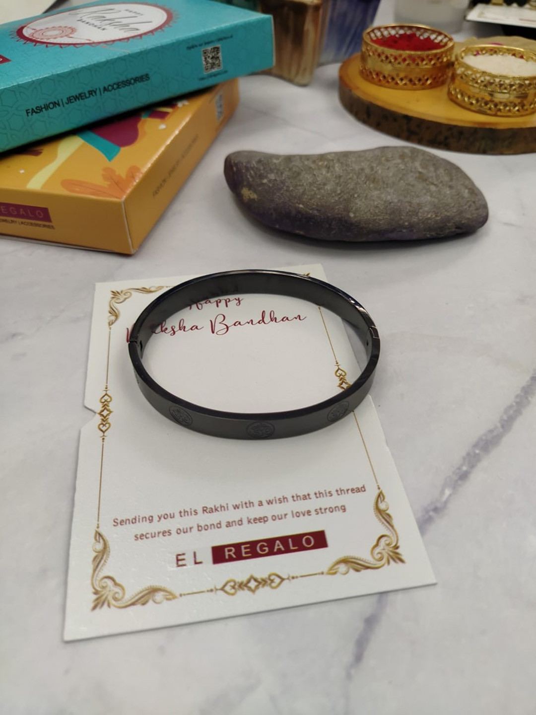 

EL REGALO Men Om Band Stainless Steel Rakhi With Roli Chawal & Greeting Card, Black