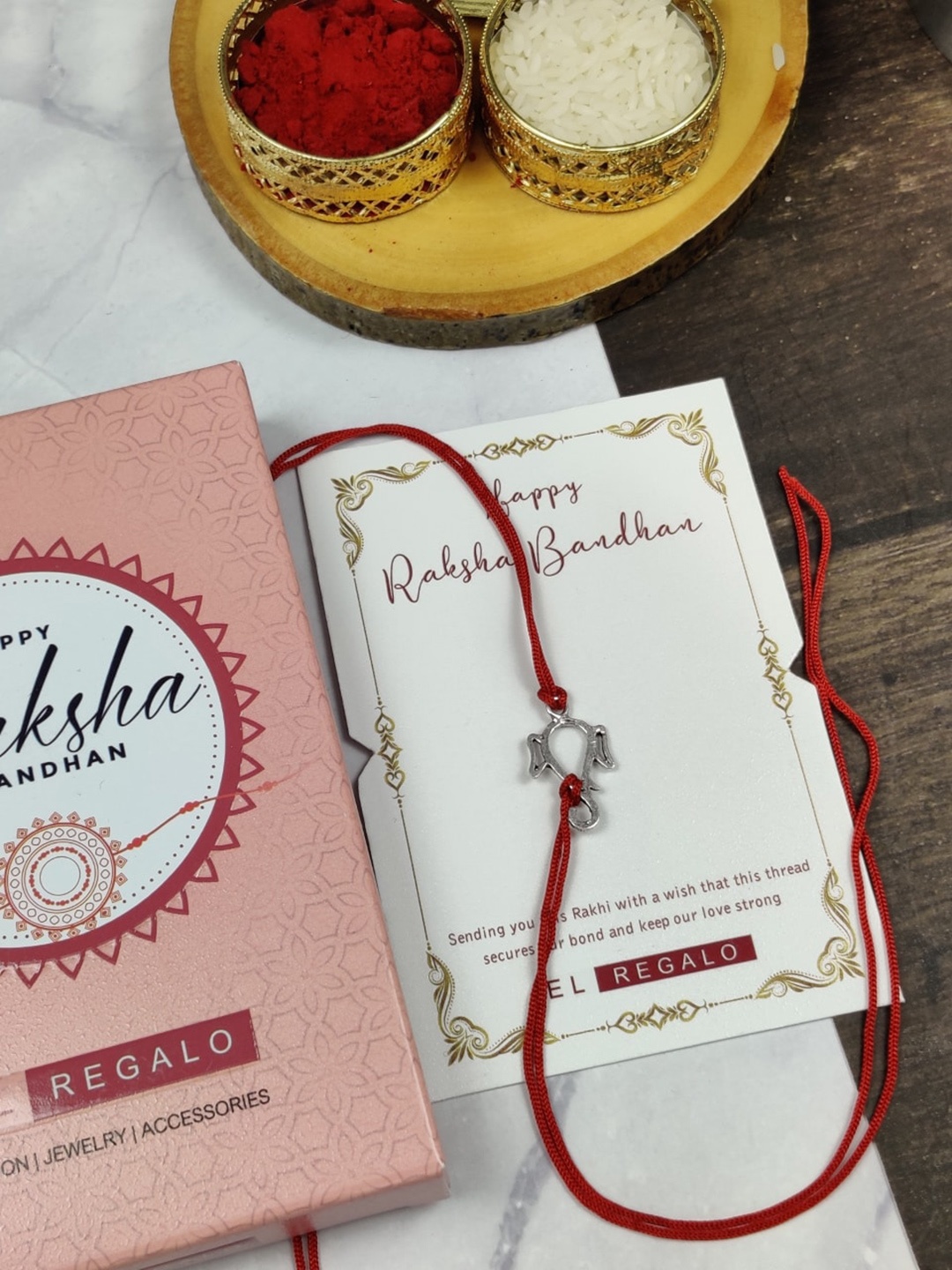 

EL REGALO Ganesha Charm Thread Silver Rakhi with Card and Roli Chawal Shagun