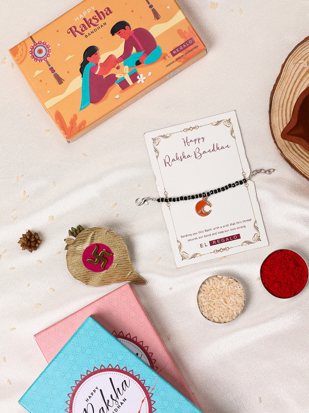 

EL REGALO Kids Beaded Moon Shaped Charm Rakhi With Roli & Chawal & Card, Orange