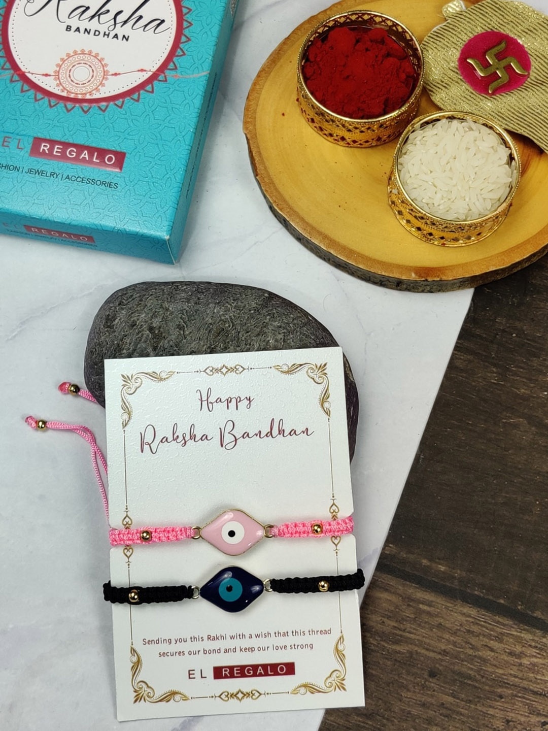 

EL REGALO Bhaiya Bhabhi Set Of 2 Evil Eye Charm Rakhi Combo Roli With Chawal, Pink