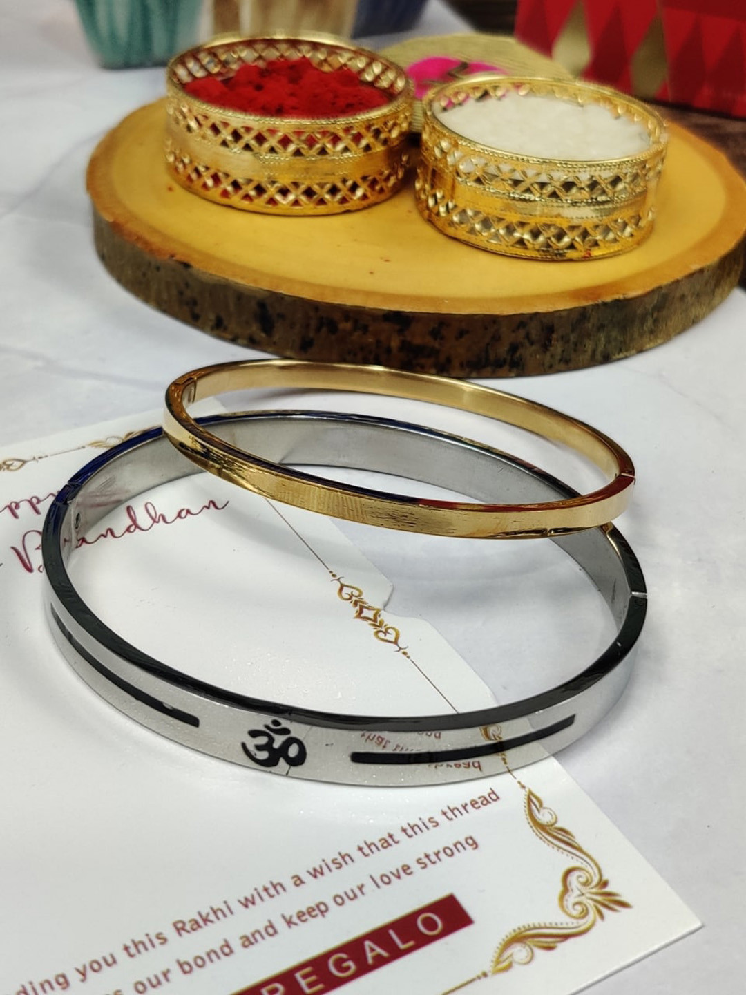 

EL REGALO Bhaiya Bhabhi Set Of 2 Kada Bracelet Stainless Steel Rakhi With Roli Chawal Card, Gold