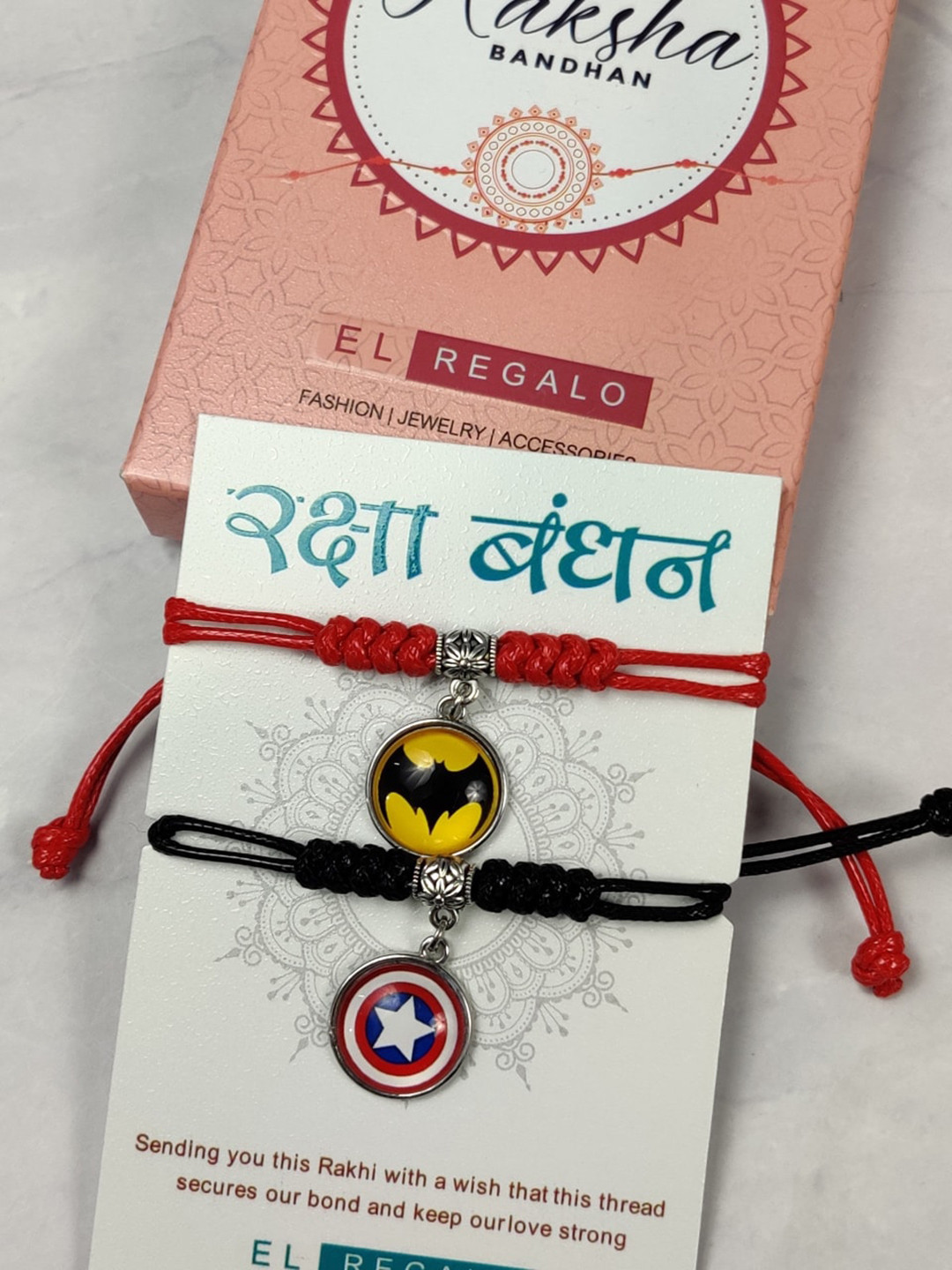 

EL REGALO Kids Set Of 2 Batman & Captain America Charm Detail Rakhis With Roli & Chawal, Red