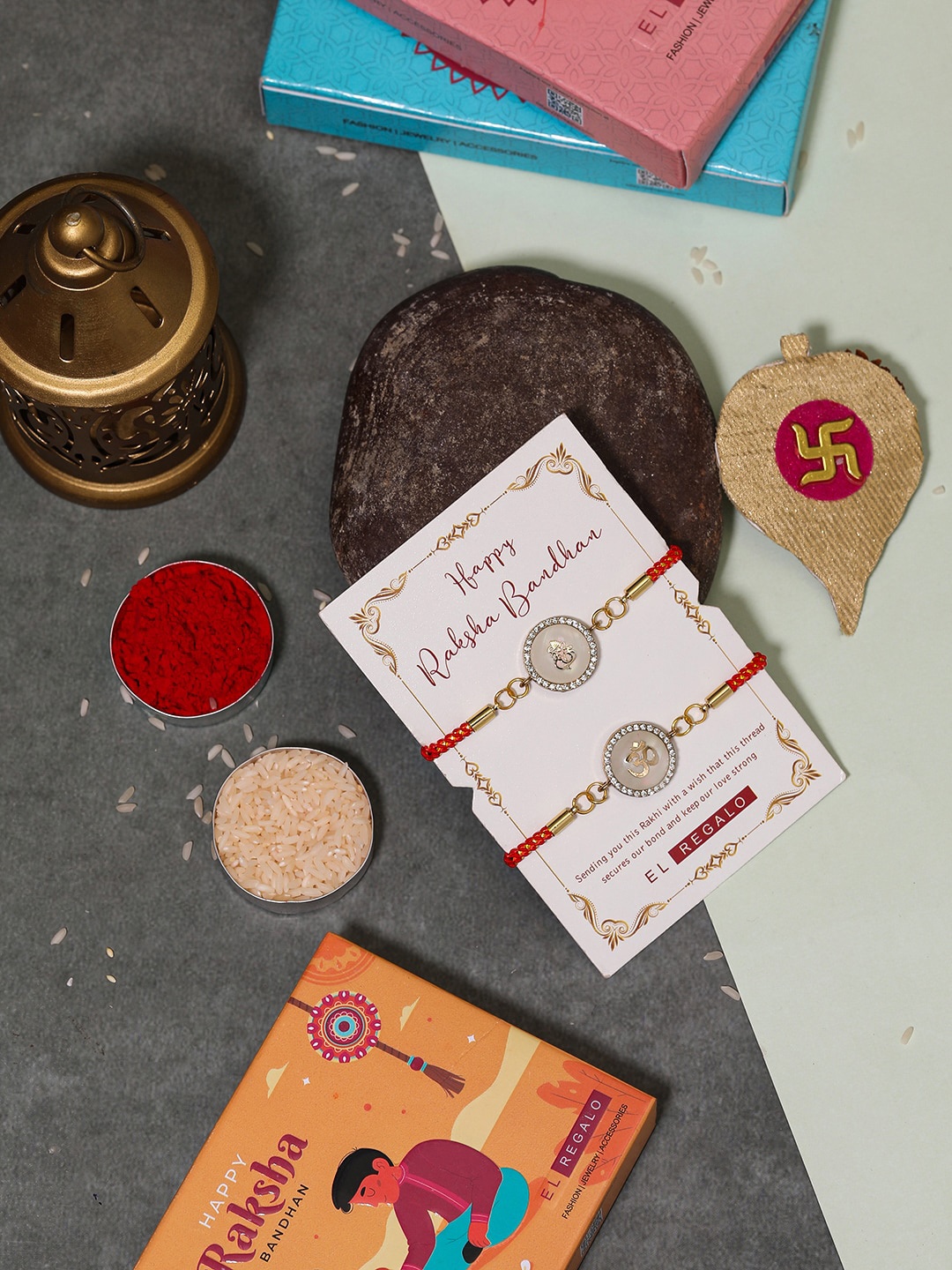 

EL REGALO Bhaiya Bhabhi Set Of 2 Charm Rakhi Combo With and Card, Roli Chawal, Red