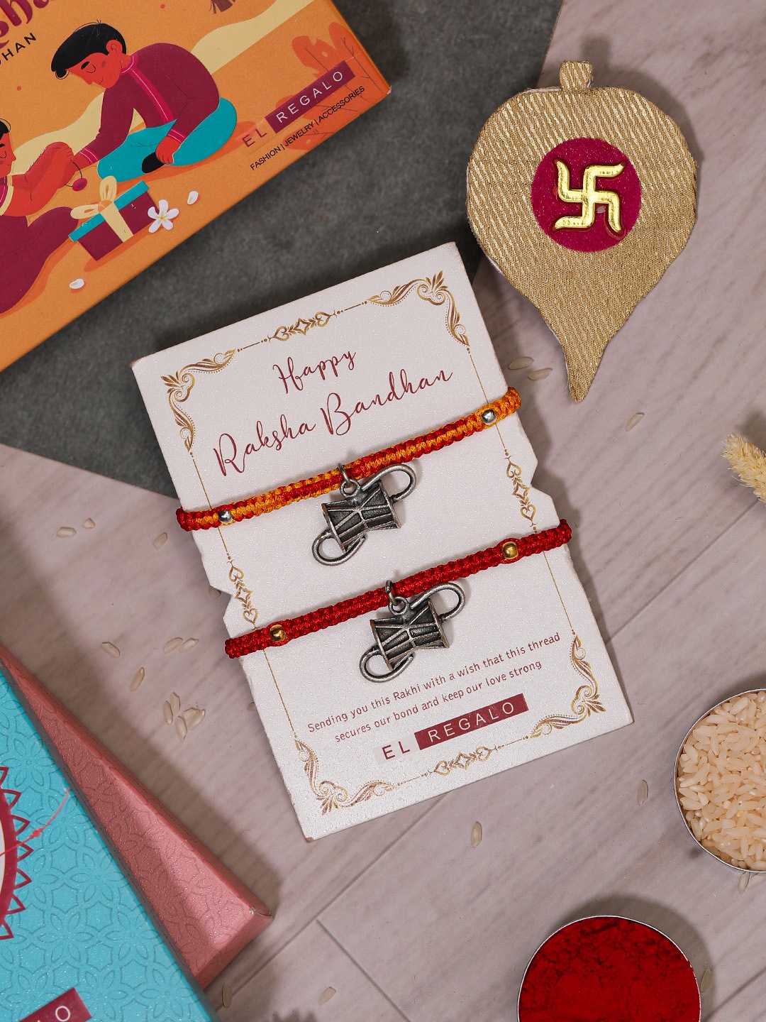 

EL REGALO Bhaiya Bhabhi Set Of 2 Charm Rakhi Combo With Roli Chawal, Red
