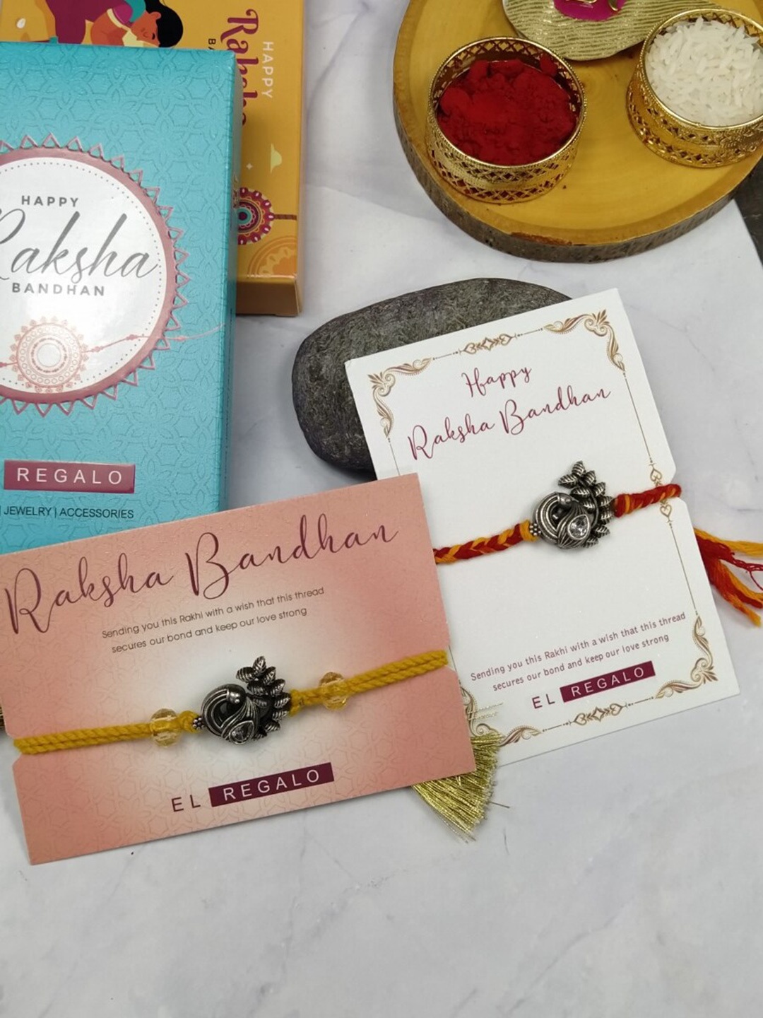 

EL REGALO Bhaiya Bhabhi Set Of 2 Charm Rakhi Combo With Roli Chawal, Red