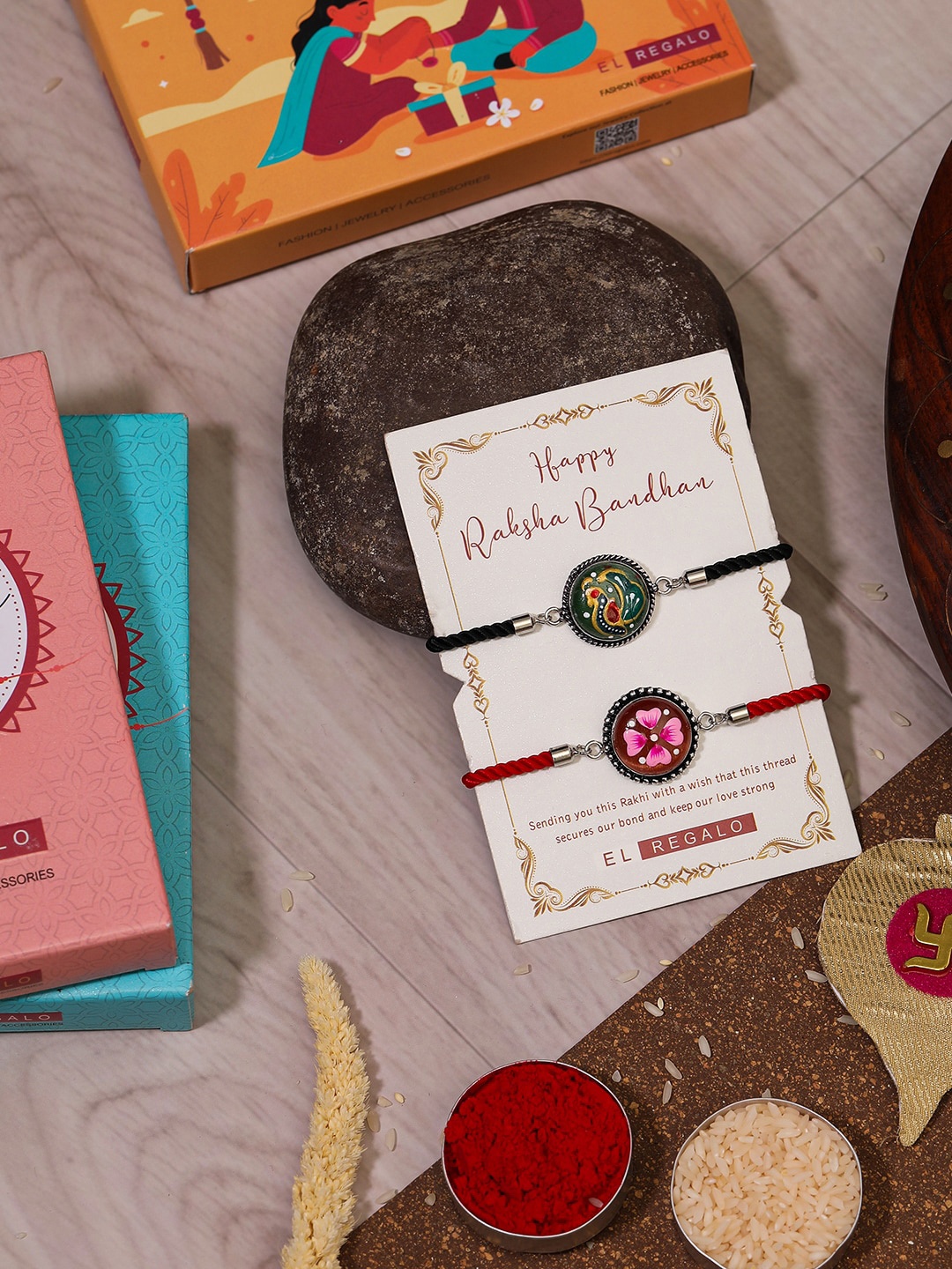 

EL REGALO Bhaiya Bhabhi Set Of 2 Charm Rakhi Combo With and Card, Roli Chawal, Red