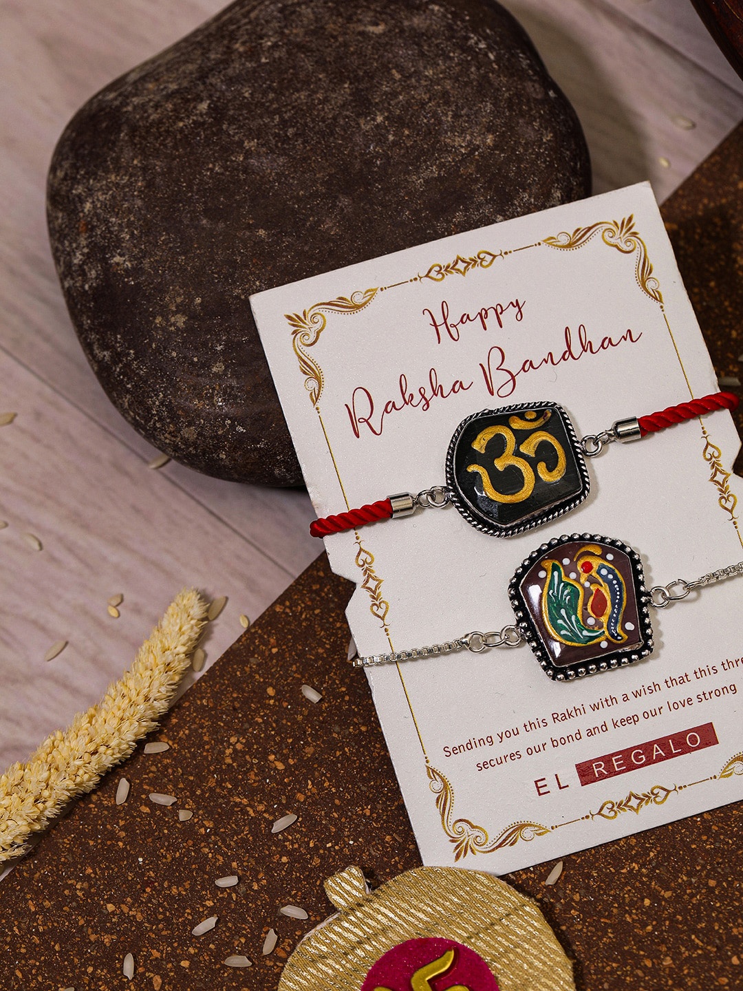 

EL REGALO Bhaiya Bhabhi Set Of 2 Charm Rakhi Combo With Roli Chawal, Red