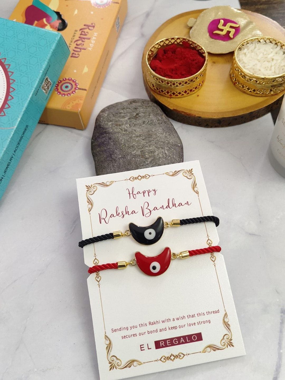 

EL REGALO Bhaiya Bhabhi Set Of 2 Evil Eye Rakhi Combo With Roli Chawal, Red