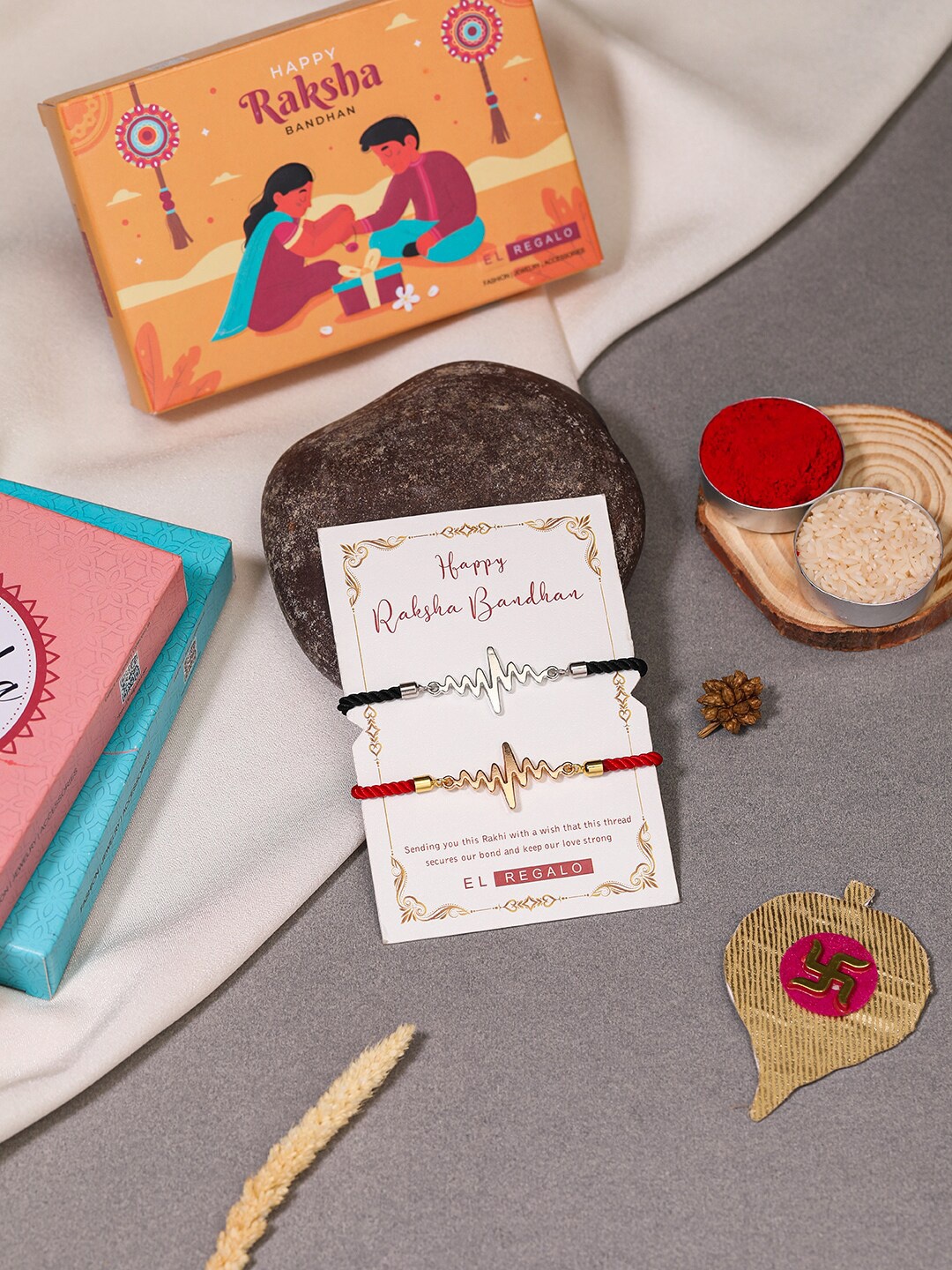 

EL REGALO Bhaiya Bhabhi Set Of 2 Charm Rakhi Combo With and Card, Roli Chawal, Red