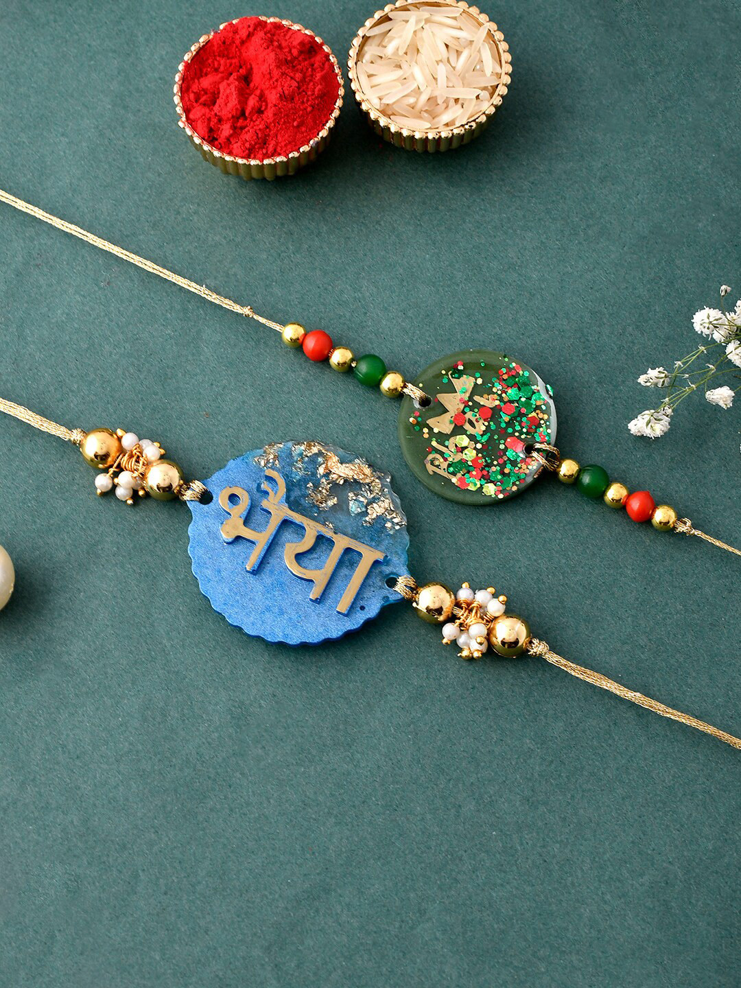 

Aapno Rajasthan Set Of 2 Bhaiya Resin Rakhi With Greeting Card & Roli Chawal, Blue