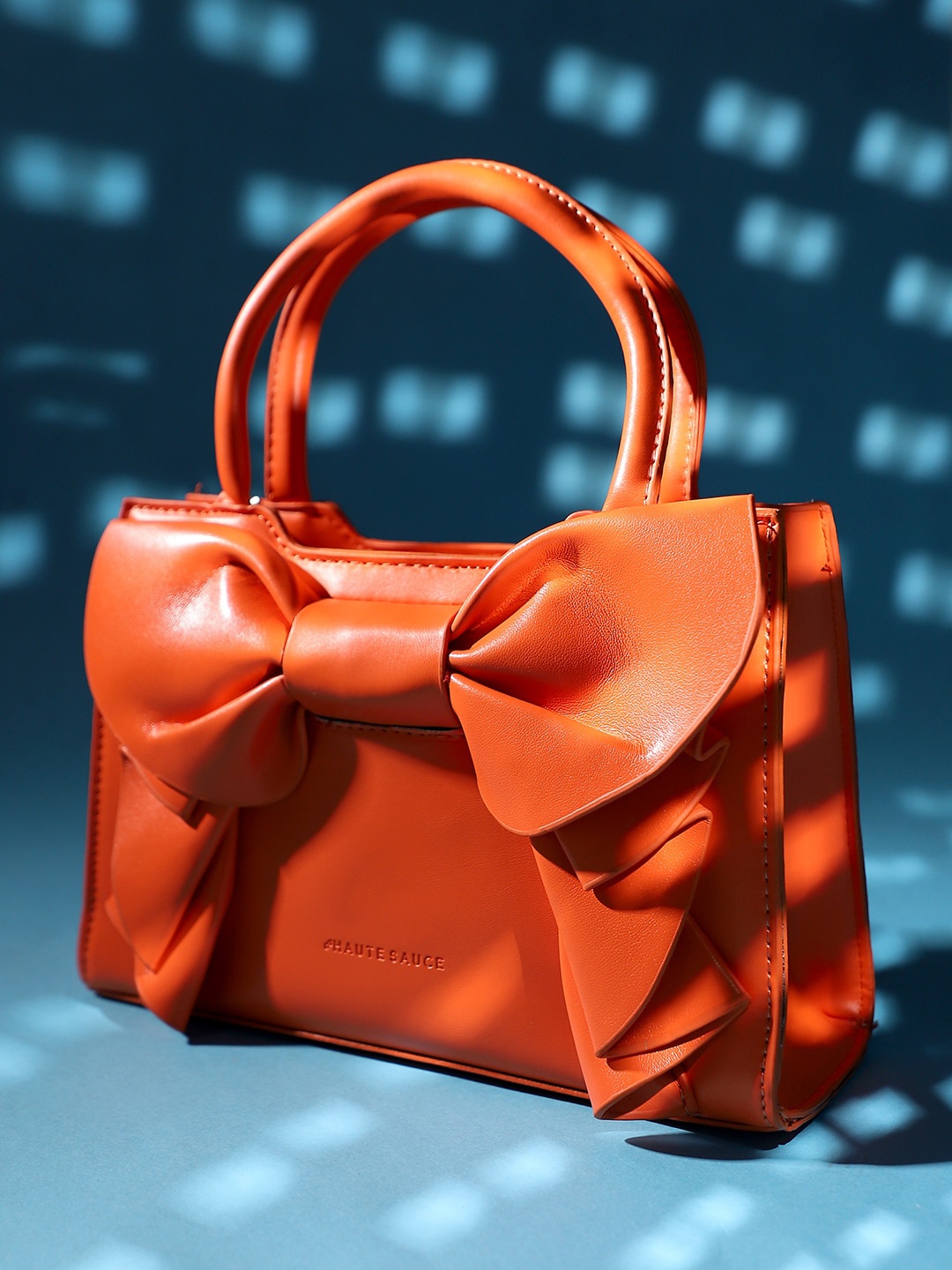 

HAUTE SAUCE by Campus Sutra Structured Handheld Bag With Bow Detail, Orange