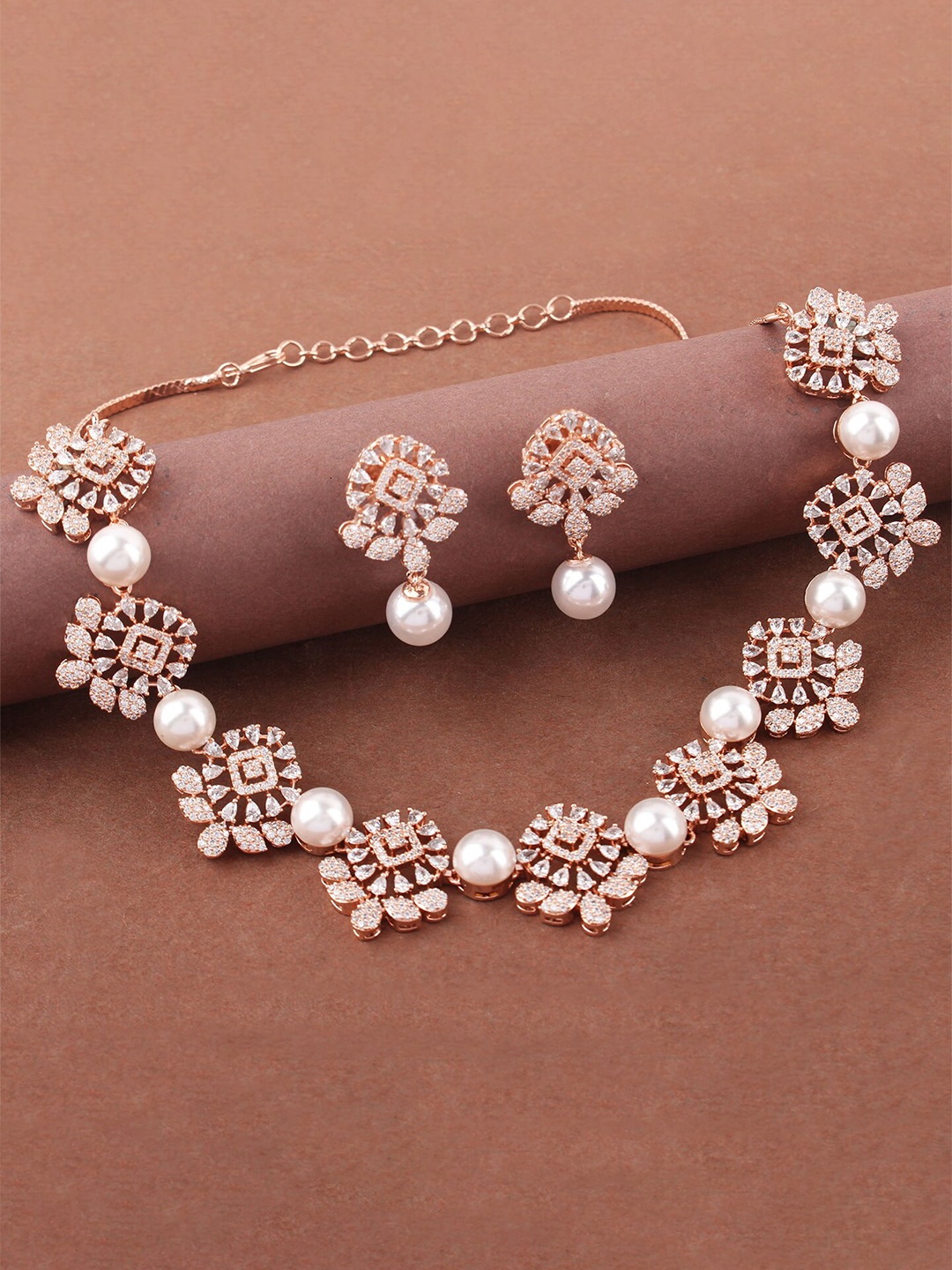 

Mirana Rose Gold Plated American Diamond Stone Studded Ovie Pearl Beaded Jewellery Set