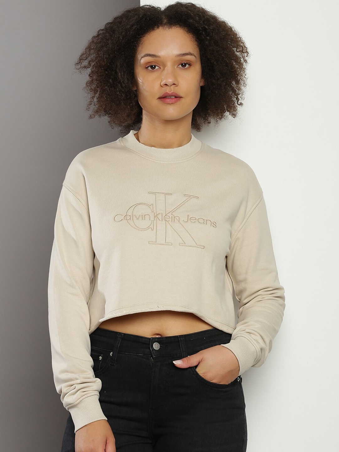 

Calvin Klein Jeans Brand Logo Printed Round Neck Pullover Crop Sweatshirt, Beige