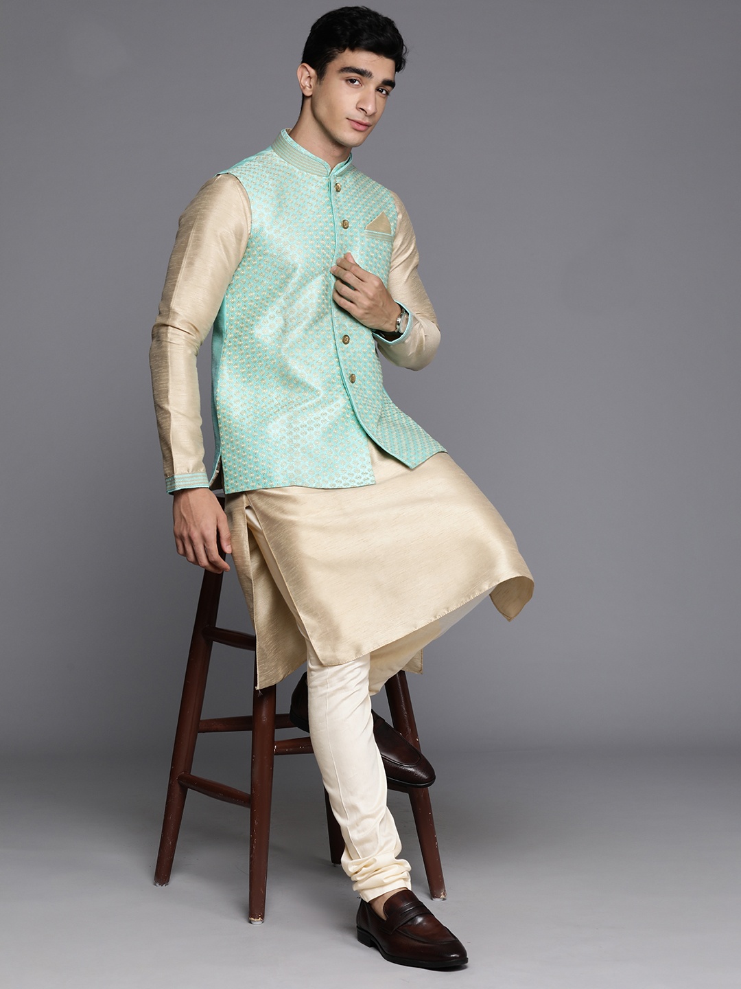 

Manu Men Solid Mandarin Collar Kurta With Churidar & Embroidered Nehru Jacket, Gold