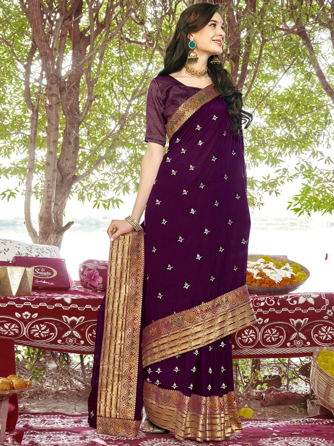 

Mitera Purple & Blue Ethnic Motifs Embellished Zari Saree